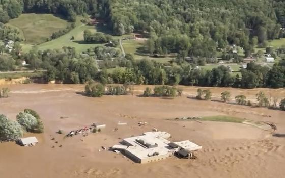 This image taken from video from the Tennessee Emergency Management Agency shows a helicopter on the roof of Unicoi County Hospital in Erwin, Tenn., where patients and staff had to be rescued from after the Nolichucky River flooded and surrounded the building from Hurricane Helene, Friday, Sept. 27, 2024. (Tennessee Emergency Management Agency via AP)