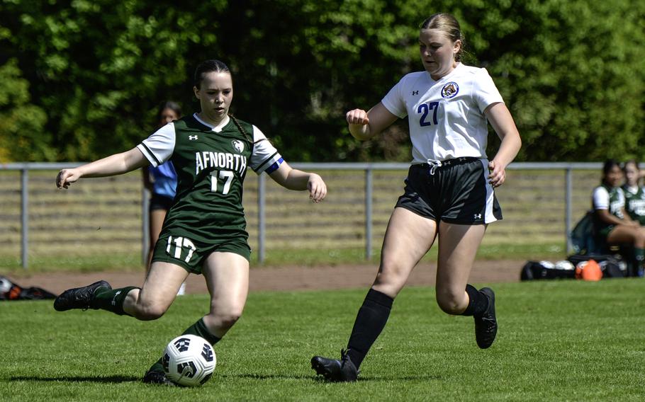 Isabella Guest of AFNORTH pushes past Brussels' Taegan Muller during the 2024 DODEA European Soccer Division III Championships in Landstuhl, Germany, on May 20, 2024. AFNORTH won the game 5-0.