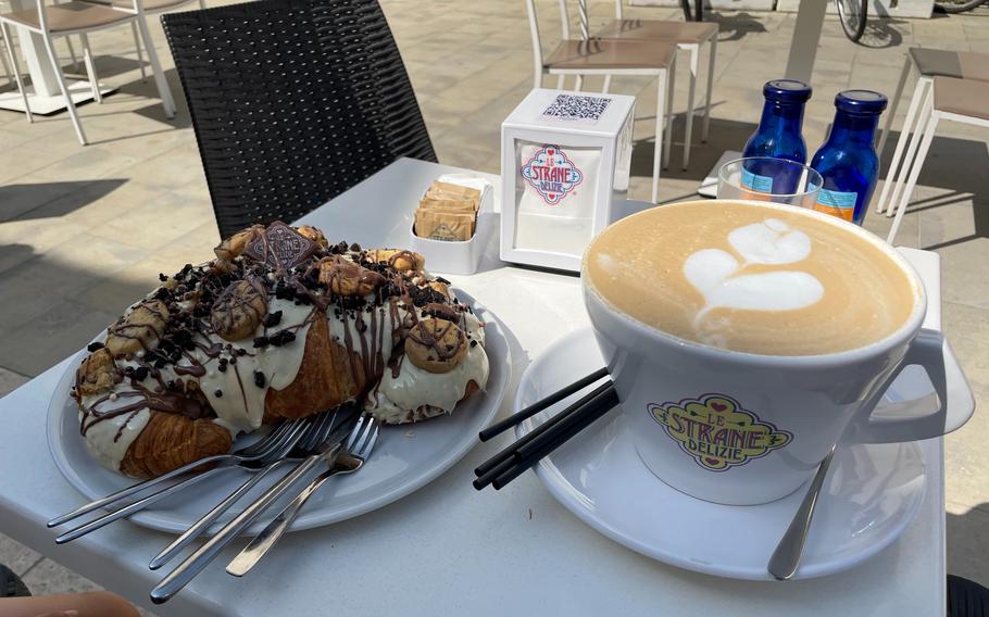 A mega brioche covered in melted white chocolate served alongside the mega cappuccino at Le Strane Delizie in Spilimbergo, Italy, on Aug. 17, 2024.