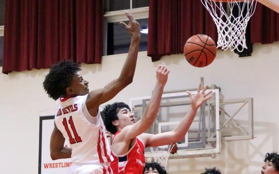 Kinnick's Isaiah Kimbrough and Yokohama International's Kai Hicks sky for a rebound.