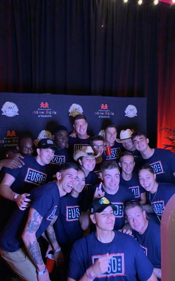 Service members from Fort Campbell, Ky. pose for a group picture at Bridgestone Area on July 29, 2024, in Nashville, Tenn.