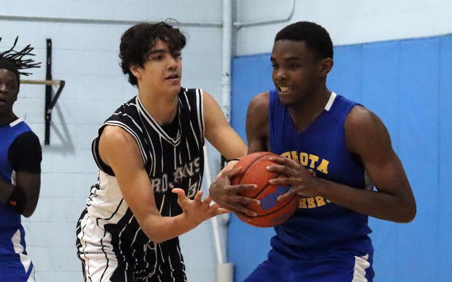 Asher Jorgensen and Baron Reed battle for the ball.