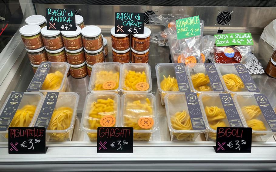 Fresh pasta is shown for sale.