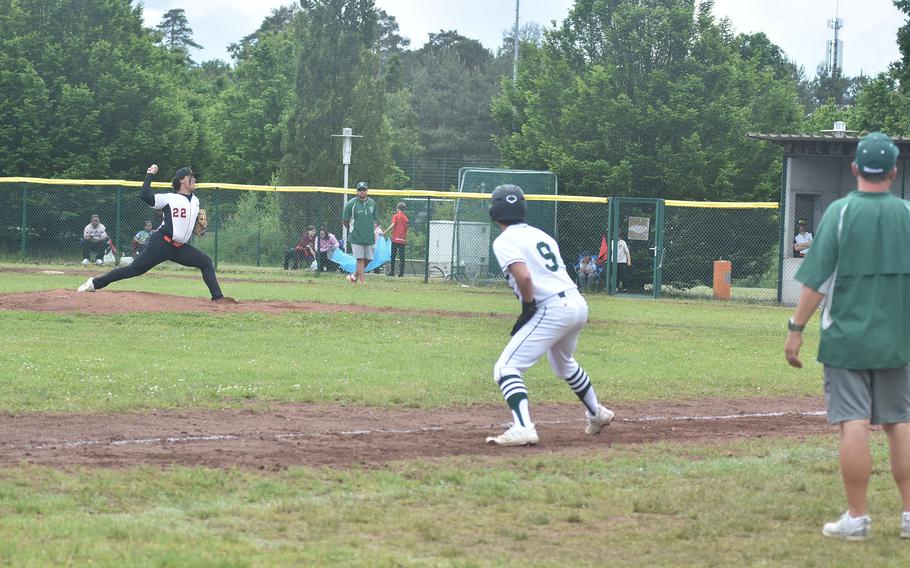 Naples' Logan Barker takes a big lead off third base Friday, May 24, 2024, while Spangdahlem's Casey Supinger makes a pitch at the DODEA European Division II/III championship game at Ramstein Air Base, Germany.