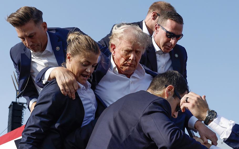 Secret Service agents take former President Donald Trump to safety