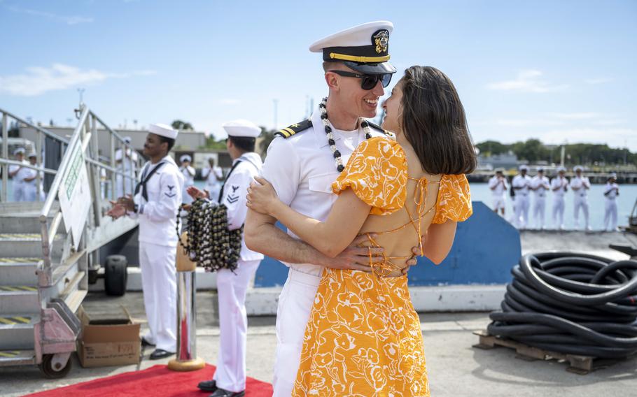 A sailor embraces his girlfriend