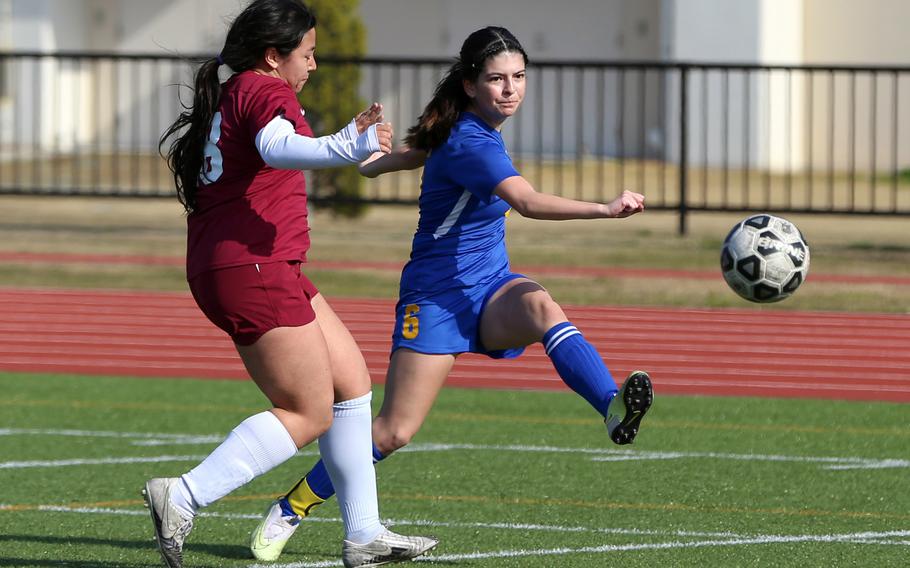 Yokota's Jessica Franks boots the ball past Perry's Markeean Lutz during Saturday's DODEA-Japan girls soccer match. The Panthers won 6-3.
