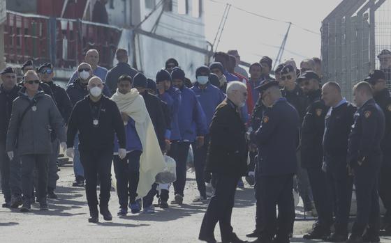 Migrants follow the authorities after their arrival, as Italy sent 49 people to Albania for processing following earlier court rejections to Albania, in Shengjin, northwestern Albania, Tuesday, Jan. 28, 2025. (AP Photo/Vlasov Sulaj)