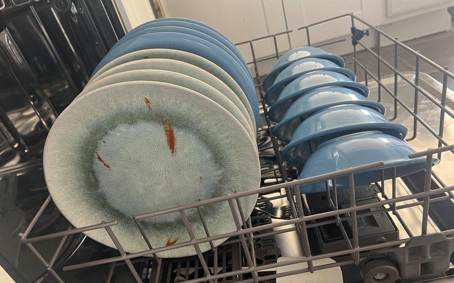 Rachel Kurzius’ rinsed dishes before going through the dishwasher. 