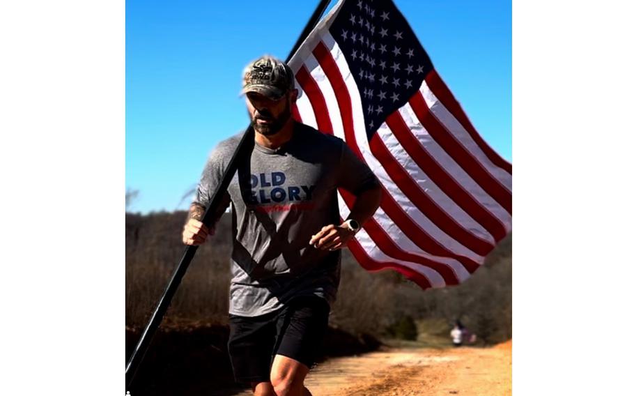 U.S. Army veteran Jason Wood runs with the American flag