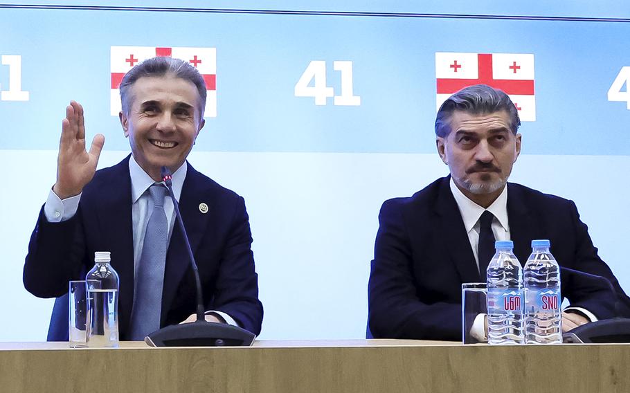 In this photo released by the Georgian Dream party, Bidzina Ivanishvili, leader of the created Georgian Dream party which he initiated, left, gestures as Mikheil Kavelashvili, who was nominated by the governing Georgian Dream party, sits next during a session to discussing Presidential candidate in Tbilisi, Georgia, Wednesday, Nov. 27, 2024. 