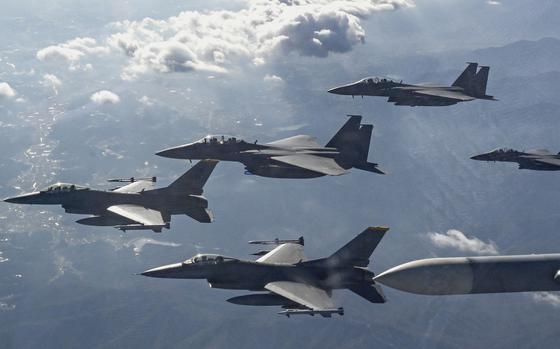 A group of five fighter jets flies in formation.