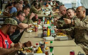 Deployed U.S. service members come together for a Thanksgiving meal at Air Base 201, Niger, Nov. 23, 2023. Installation senior leadership served traditional foods to personnel to enhance the “home away from home” atmosphere. (U.S. Air Force photo by Tech. Sgt. Rose Gudex)