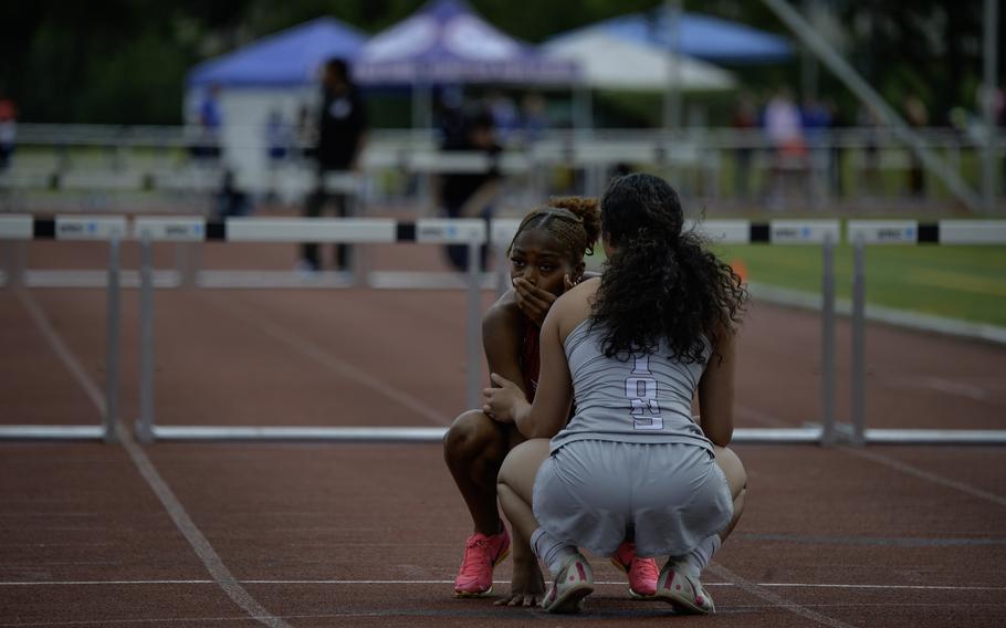 AFNORTH’s Richele Reyes comforts Kaiserslautern’s sophomore Lellah Guhn after she was disqualified during the girls 300-meter hurdles at the 2024 DODEA European Championships at Kaiserslautern High School in Kaiserslautern, Germany, on May 24, 2024.