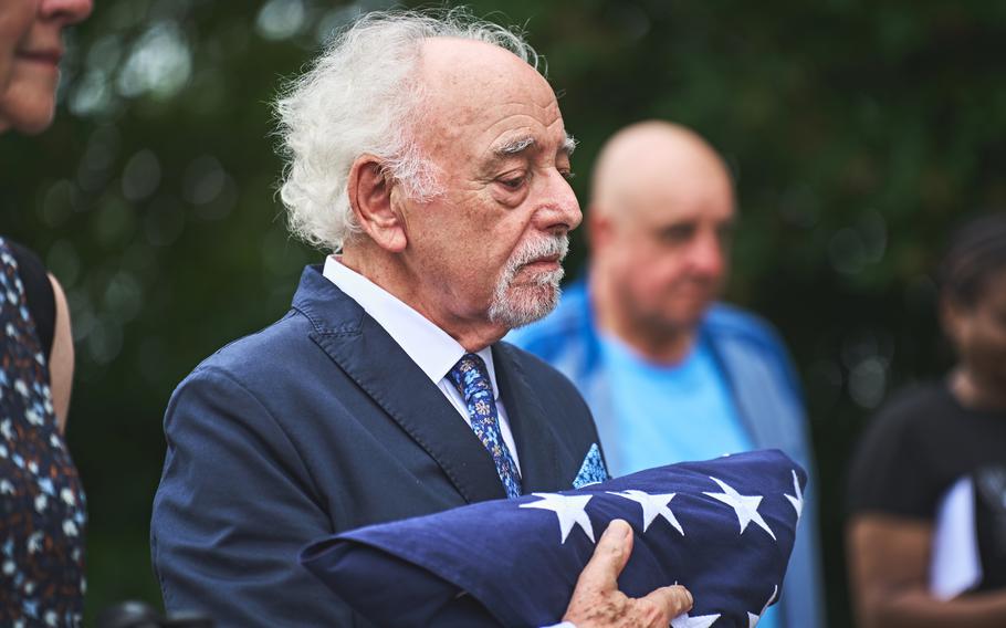 David Frost, grandson of Civil War veteran Pvt. James Schobel White, receives a folded flag at the East London Cemetery, England, Aug. 10, 2024.