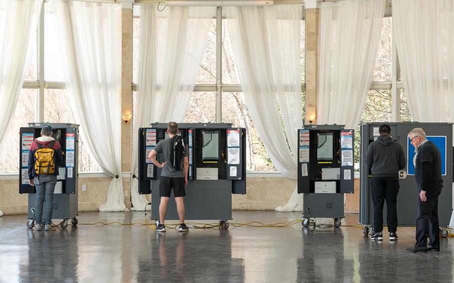 Voters in Atlanta standing at voting booths.