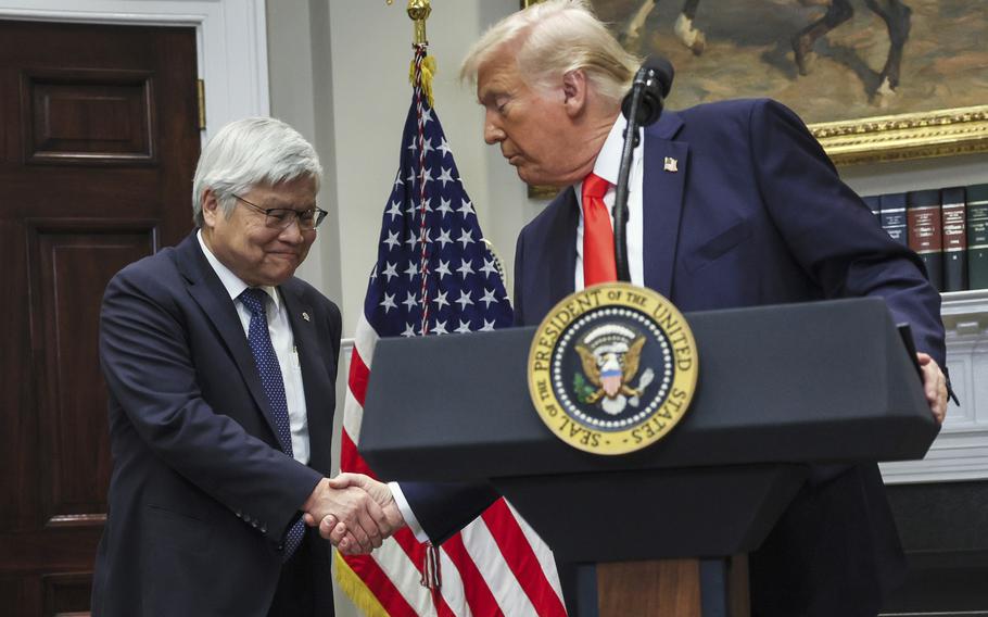 Donald Trump shakes hands with C.C. Wei.