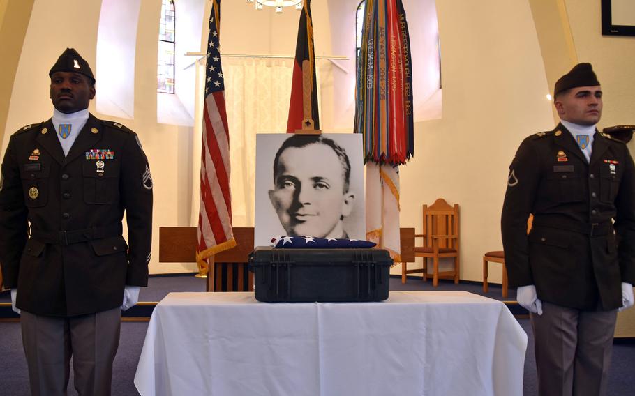 Members of the 21st Theater Sustainment Command honor guard stand next to the remains and an enlarged photograph of Army 1st Lt. Nathan Baskind during a dignified recovery of remains ceremony at the Landstuhl Regional Medical Center chapel in Germany on Tuesday, May 28, 2024.