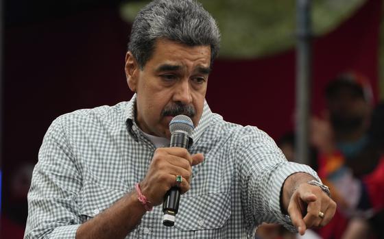 Venezuela's President Nicolas Maduro addresses government loyalists gathered at the presidential palace in support of his reelection one month after the presidential vote, in Caracas, Venezuela, Wednesday, Aug. 28, 2024. (AP Photo/Ariana Cubillos)