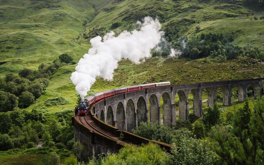 Glenfinnan Viaduct with a train on tracks