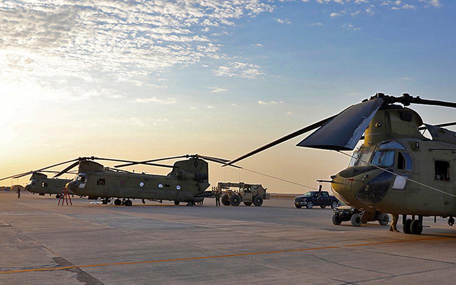 U.S. Army soldiers conduct preflight checks and load cargo onto CH-47 Chinooks Aug. 27, 2023, at al Asad Air Base, Iraq. Five U.S. service members and two American contractors were injured when two rockets struck the base Aug. 5, 2024, a defense official said on Aug. 6. 