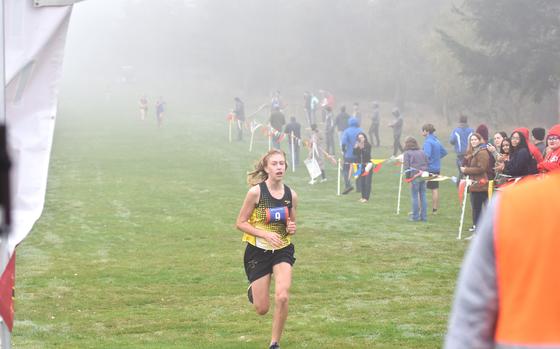 Stuttgart freshman Anna Konon runs towards the finish chute ahead of the field at the DODEA Europe Cross Country Championships on Saturday, Oct. 26, 2024. Konon covered the 3.1-mile course at the Rolling Hills Golf Course in Baumholder, Germany, in 20:15.15.