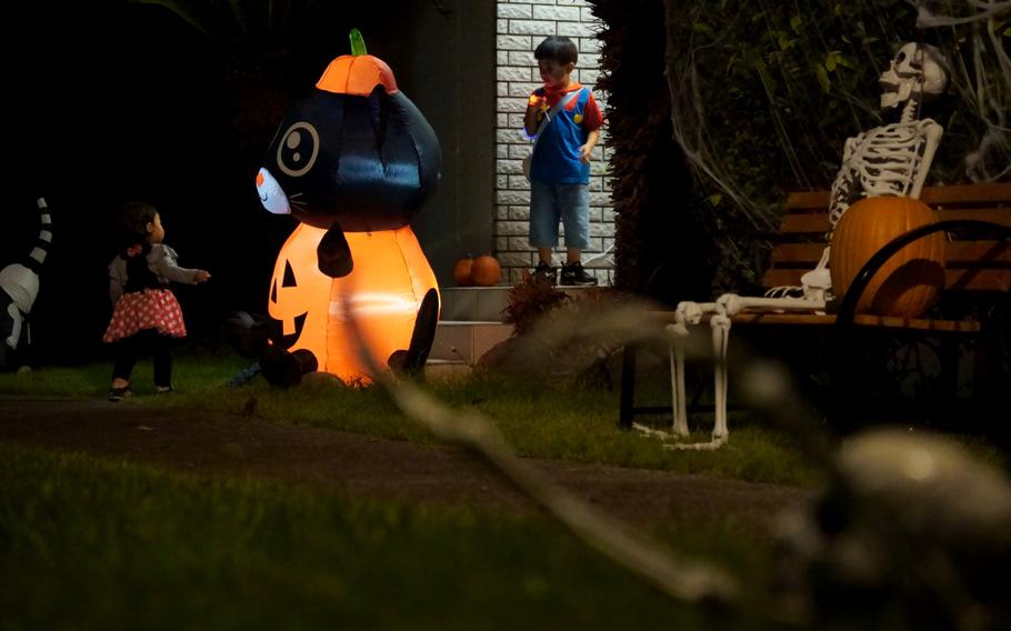 Trick-or-treaters check out Halloween decorations outside a home at Yokosuka Naval Base, Japan, Oct. 31, 2024.