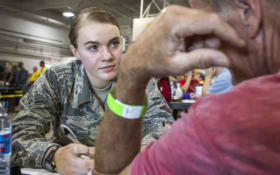 U.S. Air Force Airman Hannah E. Uron, Aerospace Medical Technician, 177th Fighter Wing, New Jersey Air National Guard, performs a health assessment on a homeless veteran during the Sgt. 1st Class Robert H. Yancey Sr. Stand Down at the National Guard Armory in Cherry Hill, N.J., Sept. 27, 2019. New Jersey National Guard Soldiers and Airmen cooked meals and provided medical assistance at the Stand Down where 187 homeless veterans were provided with access to healthcare, mental health screening, substance abuse counseling, social services - food stamps and unemployment, legal services, religious counseling, a hot meal, a haircut, and winter clothing. Stand Downs are grass roots, community-based assistance programs to help veterans’ battle life on the streets and serve as a catalyst that enables homeless veterans to re-enter mainstream society. (New Jersey National Guard photo by Mark C. Olsen)