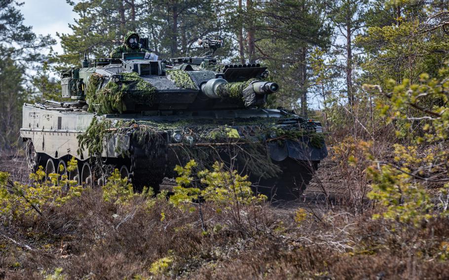 Finnish soldiers maneuver a German-made Leopard 2A6 tank