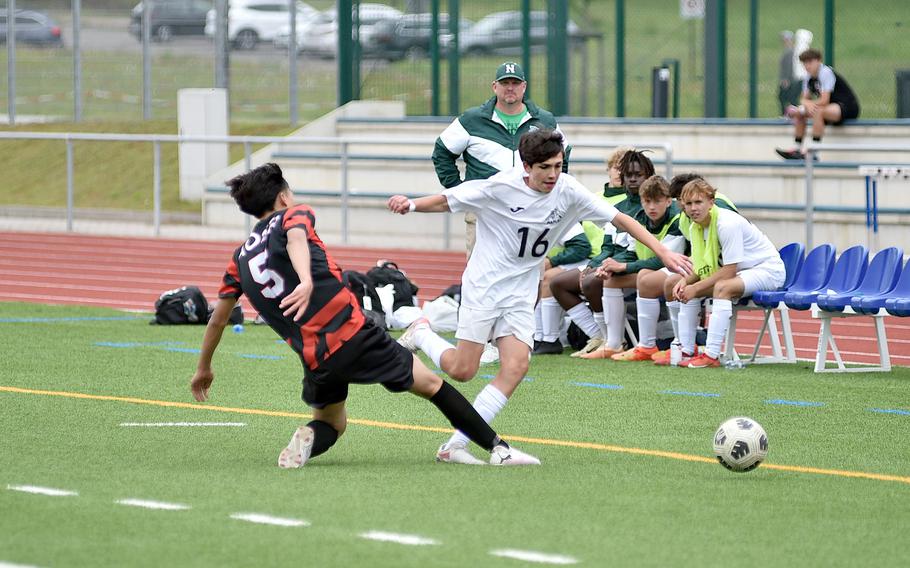 Naples freshman Finn Stephens gets fouled by American Overseas School of Rome defender MengPeng Jiang during the Division II title match at the DODEA European soccer championships on May 23, 2024, at Ramstein High School on Ramstein Air Base, Germany.