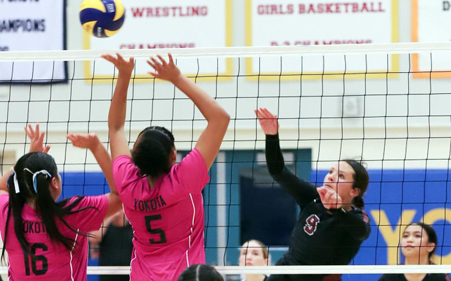 Matthew C. Perry's Brooklyn Hunter hits against two Yokota defenders during Friday's quarterfinal Far East Division II volleyball tournament match. The defending champion Panthers won in three sets.