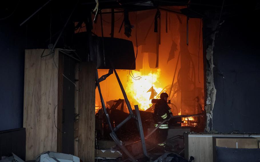 A firefighter works at a site of a household item shopping mall hit by a Russian airstrike in Kharkiv, Ukraine, May 25, 2024. 