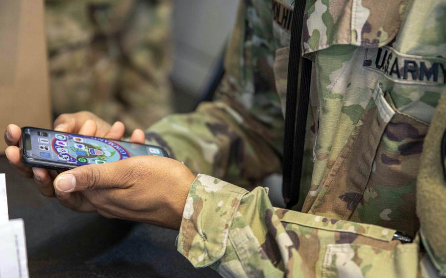 A soldier sets up a government-issued cellphone.