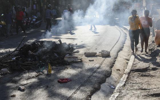 The bodies of suspected gang members who were set on fire by residents, sit in a pile in the middle of a road in the Pétion-Ville neighborhood of Port-au-Prince, Haiti.