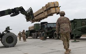 Soldiers with Charlie Battery, 5th Battalion, 7th Air Defense Artillery Regiment remove missiles from their Patriot launcher vehicles near Rzeszow-Jasionka Airport in southeast Poland on Feb. 2, 2025, a day before they officially handed over their mission to German forces. The missiles will be sent to the Army’s ammunition depot in Miesau, Germany.