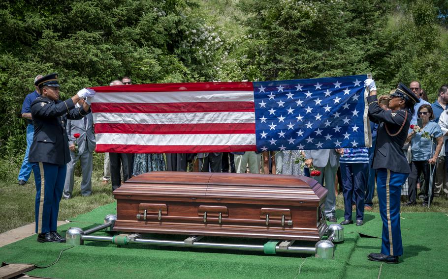 Members of the Connecticut National Guard funeral honors team prepares to fold the American flag that was draped across the casket of Tech Sgt. Kenneth McKeeman at the Connecticut State Veterans Cemetary in Middletown, Conn., June 7, 2024. 