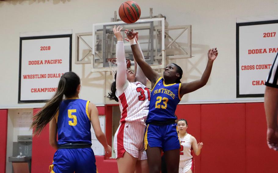 Jordan Kitts and Beverly Gardner jump for the ball.