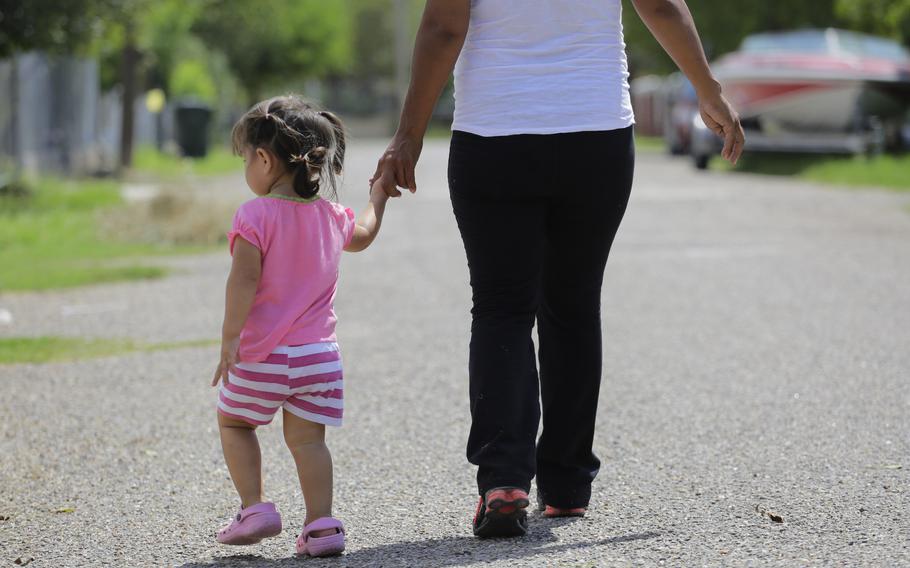 A woman walks with her daughter