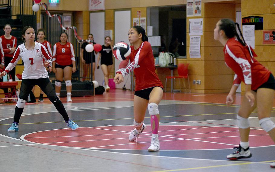 Raider Kezley Kai bumps the ball during an Oct. 6, 2023, match against Ramstein at Kaiserslautern High School in Kaiserslautern, Germany. Watching, at left, is Raider libero Marisa Branch.