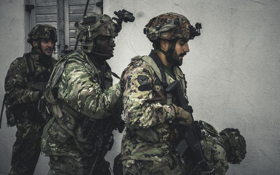 A U.S. Army paratrooper with the 173rd Airborne Brigade conducts a simulated attack with Italian troops