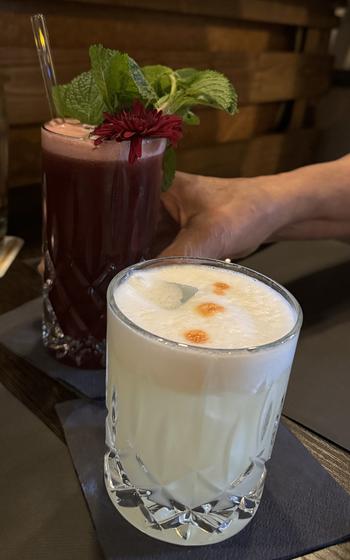 A pisco sour, foreground, and a virgin morada as served at Mi Peru in Darmstadt, Germany. The pico sour, not unlike a whiskey sour, is made with Peruvian pisco, a grape marc similar to grappa. The morada is made with chicha morada, a Peruvian beverage made from purple corn. 