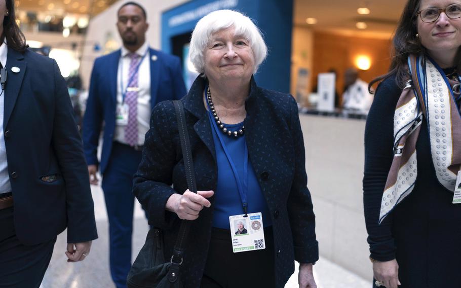 Secretary of the Treasury Janet Yellen smiles and walks