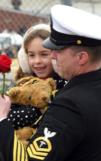 A sailor embraces his loved one