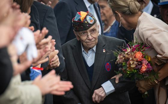 Queen Maxima of the Netherlands escorts World War II veteran Kenneth Thayer, 99, into a ceremony in Mesch, Netherlands, on Thursday, Sept. 12, 2024, to mark 80 years since the beginning of the country’s liberation during the war. 