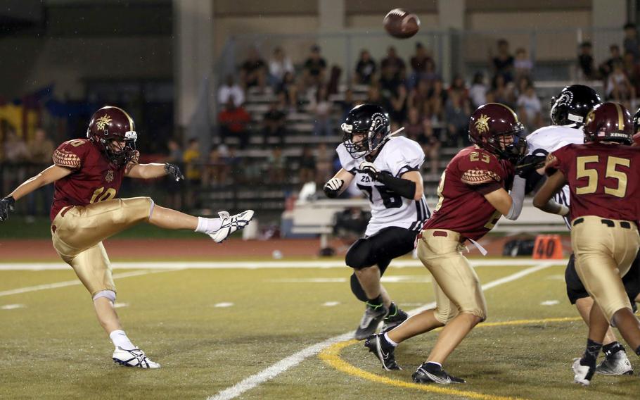 Matthew C. Perry punter Preston Ramirez boots the ball againt Zama during Friday's DODEA-Japan football game. The Trojans won 50-0.