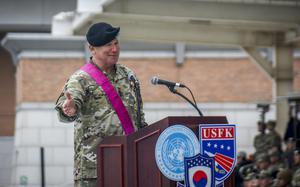 U.S. Army Gen. Paul LaCamera holds out his hand while giving a speech. 