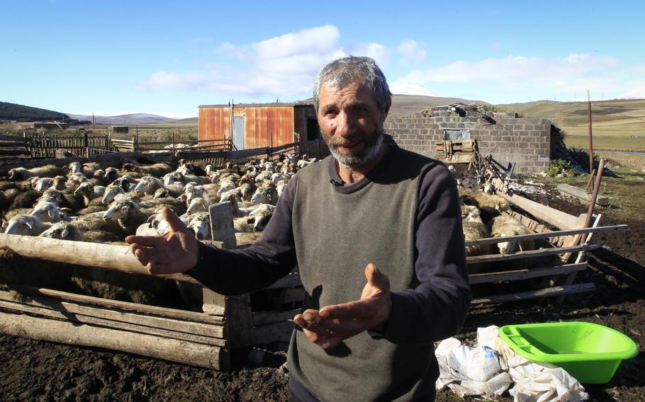 A sheep farmer in Georgia speaks to reporters during an interview at his farm, Oct. 22, 2024. 