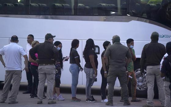 FILE - Migrants stand in line to board a bus after being deported from the U.S. side back to Matamoros, Mexico, May 11, 2023. (AP Photo/Fernando Llano, File)