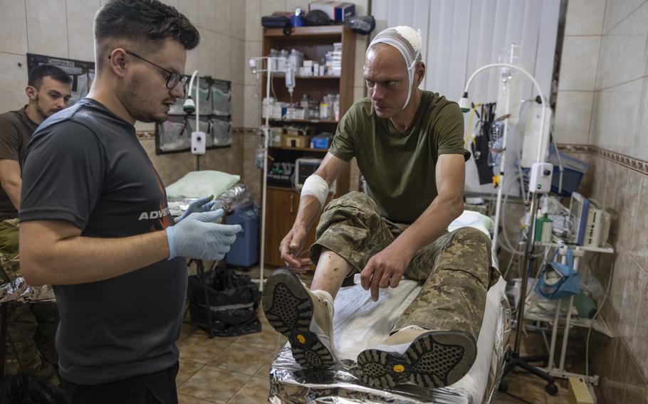 A wounded soldier is treated at a medical stabilization point in the Donbas region of Ukraine on Aug. 10.