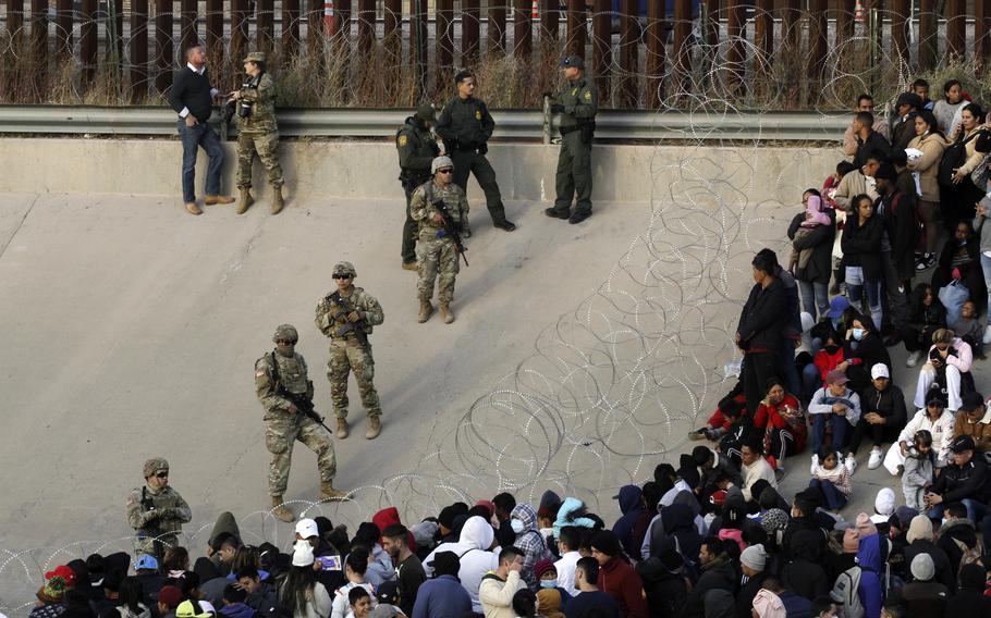 Migrants congregate on the banks of the Rio Grande at the U.S. border